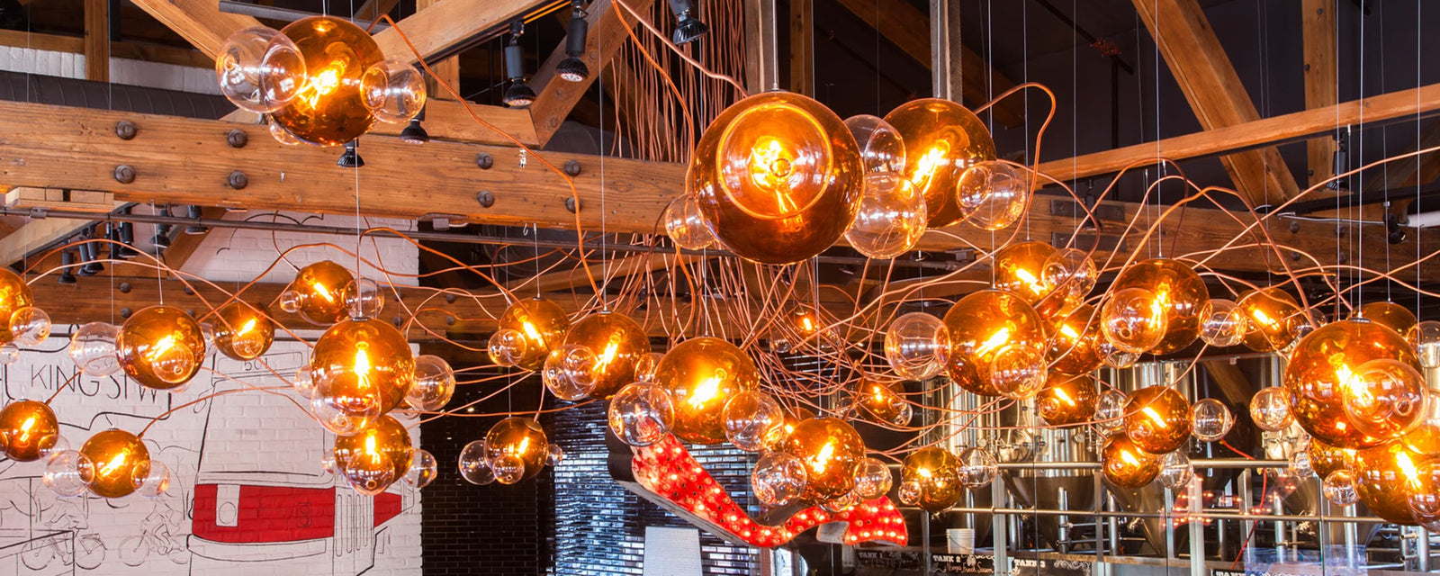 BEER-INSPIRED CUSTOM GLASS AND COPPER CHANDELIER TAKES CENTRE STAGE